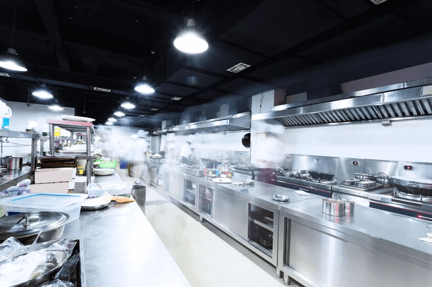 Commercial kitchen line with exhaust hoods running during active service